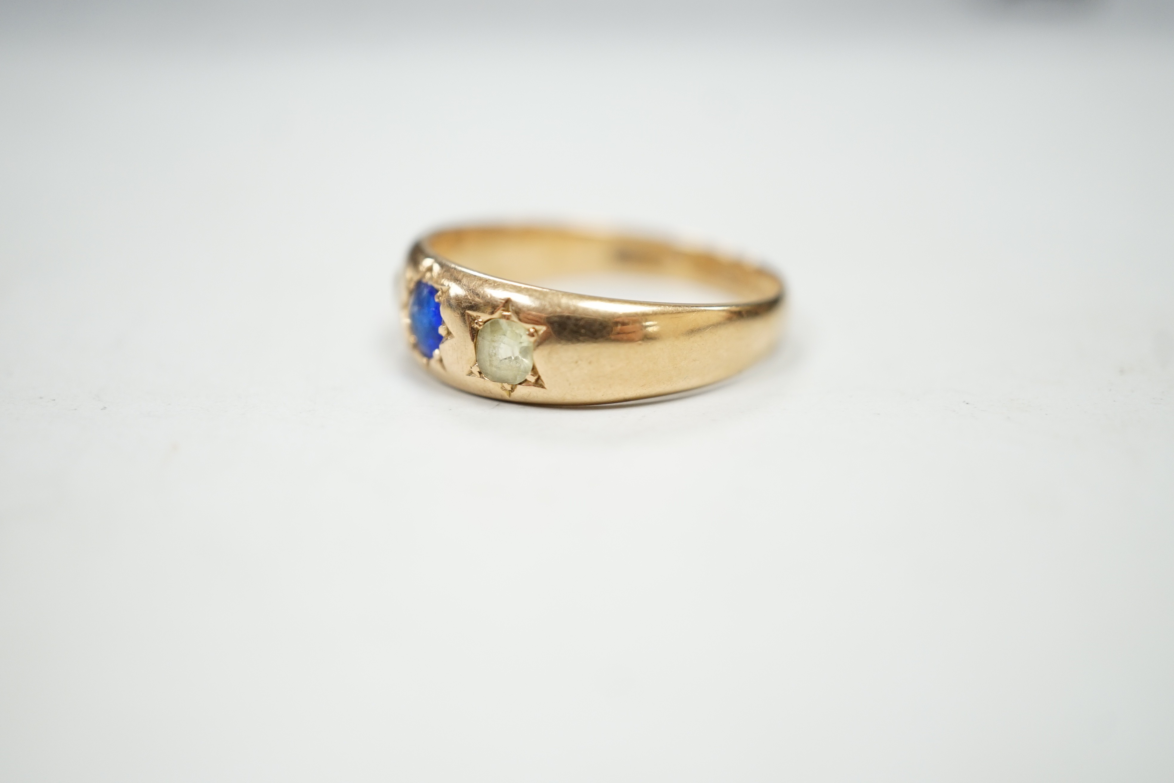 A late Victorian 15ct gold and gypsy set three stone gem set ring, size Q/R, gross weight 4.3 grams.
